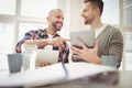 Happy businessman with colleague using digital tablet in office Royalty Free Stock Photo