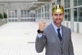 Happy businessman with a crown in office space Royalty Free Stock Photo