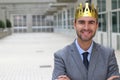 Happy businessman with a crown in office space Royalty Free Stock Photo