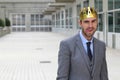 Happy businessman with a crown in office space sticking his tongue out Royalty Free Stock Photo