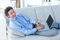 Happy businessman doing online shopping on couch Royalty Free Stock Photo