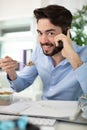 happy businessman eating salad on desk Royalty Free Stock Photo