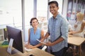 Happy businessman and female customer service representative working in office Royalty Free Stock Photo