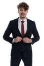 Happy businessman fixing his jacket and smiling Royalty Free Stock Photo