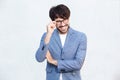 Happy businessman with glasses standing against white background Royalty Free Stock Photo