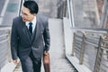 Happy businessman going to his office for work in morning by walking on steps of overpass with happy and smile face Handsome man