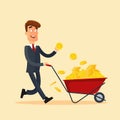 Happy businessman in grey suit pushing red cart full of money and holding gold coin in hand. Wheelbarrow with money