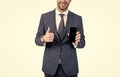 Happy businessman half face give thumbs up to approved mobile phone model, approval