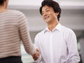 Happy businessman, handshake and meeting with colleague for agreement, deal or proposal together at office. Young asian Royalty Free Stock Photo