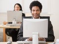 Happy businessman in headset working on computer Royalty Free Stock Photo