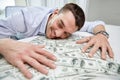 Happy businessman with heap of money in office Royalty Free Stock Photo