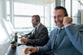 Happy Businessman with his colleagues working on computer at desk in office Royalty Free Stock Photo