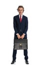 Happy businessman holding bag and smiling in front of white background Royalty Free Stock Photo