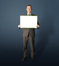 Happy businessman holding blank white card Royalty Free Stock Photo