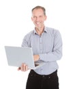 Happy businessman holding laptop Royalty Free Stock Photo