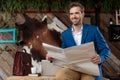 Happy businessman holding a newspaper and looking away Royalty Free Stock Photo