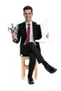 Happy businessman holding a number one and trophy Royalty Free Stock Photo