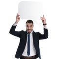 Happy businessman holding speech bubble above his head Royalty Free Stock Photo