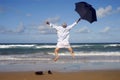 Happy businessman jumping with happiness on a beach, retirement freedom concept Royalty Free Stock Photo