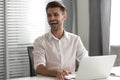 Excited businessman laughing at funny joke, having fun at work Royalty Free Stock Photo