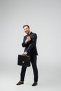 Happy businessman with leather suitcase and