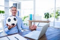 Happy businessman looking at camera and holding foot ball Royalty Free Stock Photo