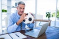 Happy businessman looking at camera and holding foot ball Royalty Free Stock Photo