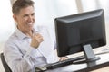 Happy Businessman Looking At Computer Monitor