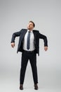 Happy businessman marionette in suit posing