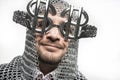 Happy, businessman with medieval executioner in metal and silver