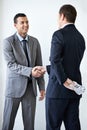 Happy businessman, money and handshake with bribe for agreement or deal on a white studio background. Man, colleagues or