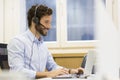 Happy Businessman in the office on the phone, headset, Skype