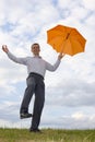 Happy businessman with orange umbrella Royalty Free Stock Photo