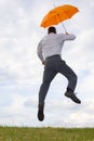 Happy businessman with orange umbrella Royalty Free Stock Photo