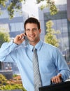 Happy businessman outside of office on phone Royalty Free Stock Photo