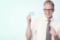 Happy businessman pointing finger at blank card. Royalty Free Stock Photo