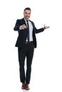 Happy businessman pointing forward and welcoming, smiling Royalty Free Stock Photo