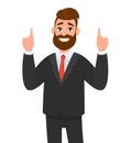 Happy businessman pointing up index fingers gesture to copy space. Man showing joyful success hand gesture to upward. Royalty Free Stock Photo
