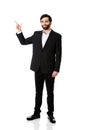Happy businessman points his finger up. Royalty Free Stock Photo