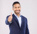 Happy businessman, portrait and thumbs up for success, approval or winning against a grey studio background. Asian man