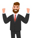 Happy businessman is raising hands in fists and happiness and success. Positive human emotion facial expression.