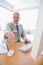 Happy businessman reaching hand out for handshake