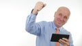 Happy Businessman Read Good Financial News on Tablet and Make Victory Hand Gestures