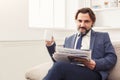 Happy businessman reading newspaper in office Royalty Free Stock Photo