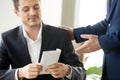 Happy businessman receiving white envelope with bribe, bribery c