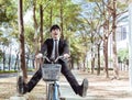 Happy Businessman riding bicycle to work on urban street Royalty Free Stock Photo