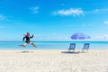 Happy businessman running from the work on the tropical beach. Summer vacation concept Royalty Free Stock Photo
