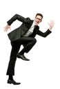 Happy businessman runs in black suit on white. Royalty Free Stock Photo