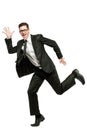 Happy businessman runs in black suit on white. Royalty Free Stock Photo