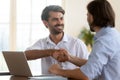 Happy businessman salesman manager handshake satisfied client at meeting